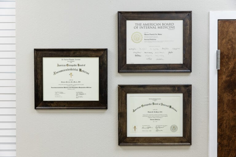 Medical diplomas and certificates on the office wall