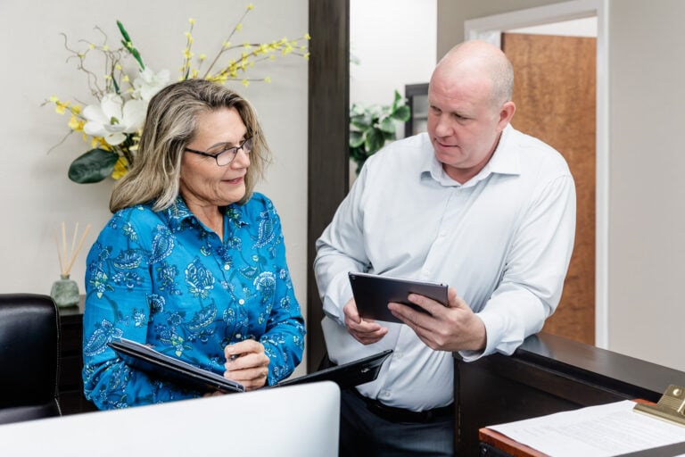 Physician and front desk team member coordinating patient care