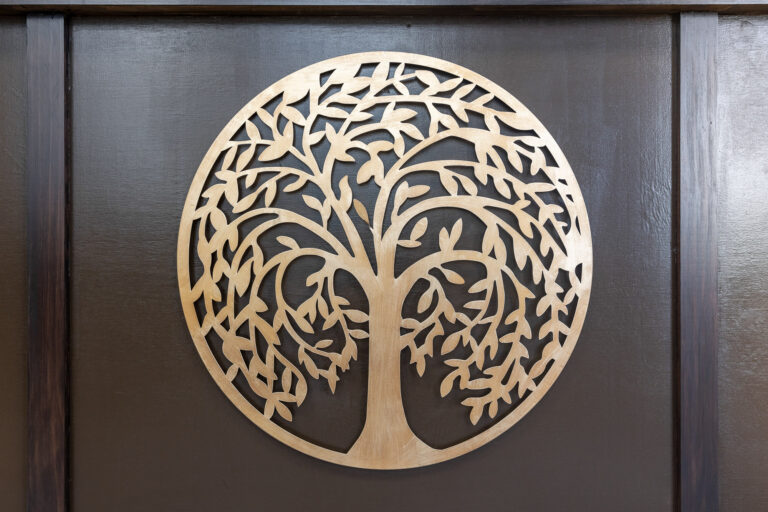 Tree-of-life logo carved into the reception desk
