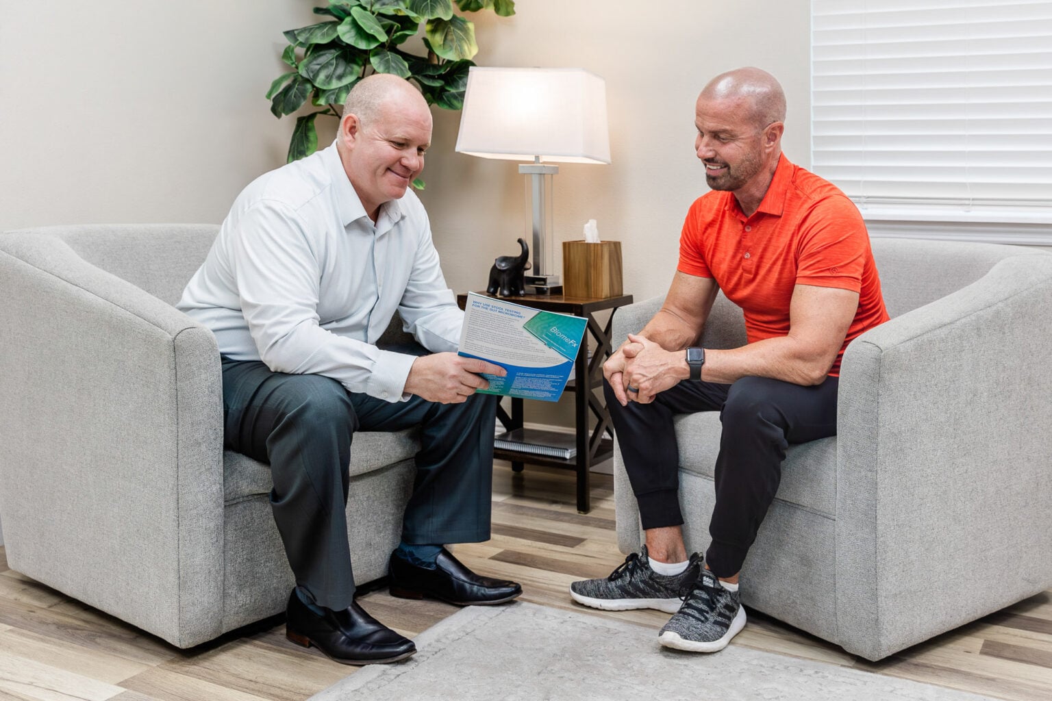 Physician reviewing a care plan with a patient in a private consultation room