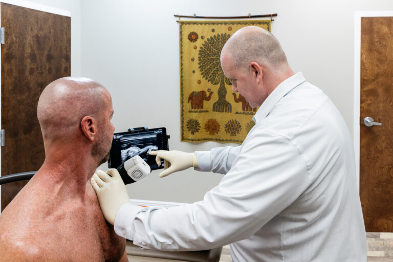 Physician performing an ultrasound-guided shoulder injection