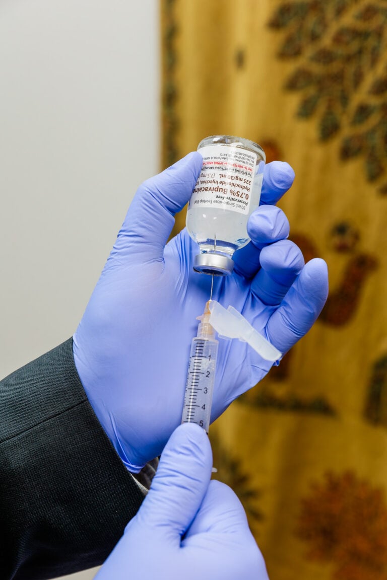 Clinician drawing medication into a syringe